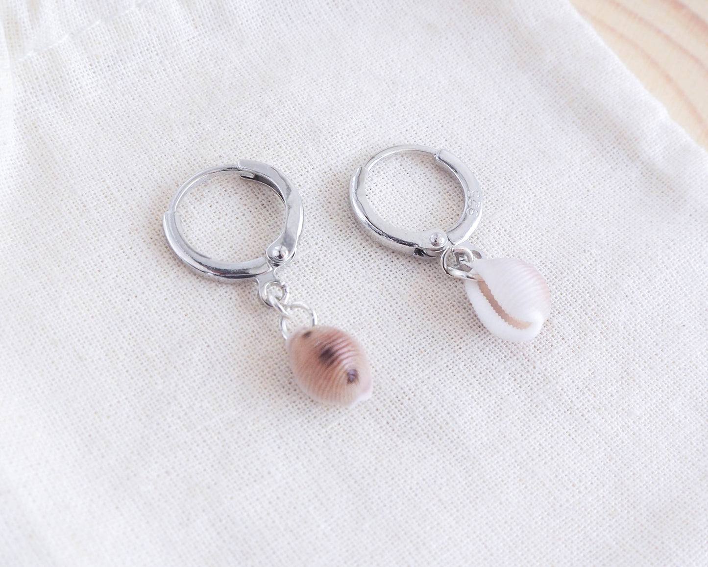 Silver Earrings with Cowrie Shells from Portugal on display