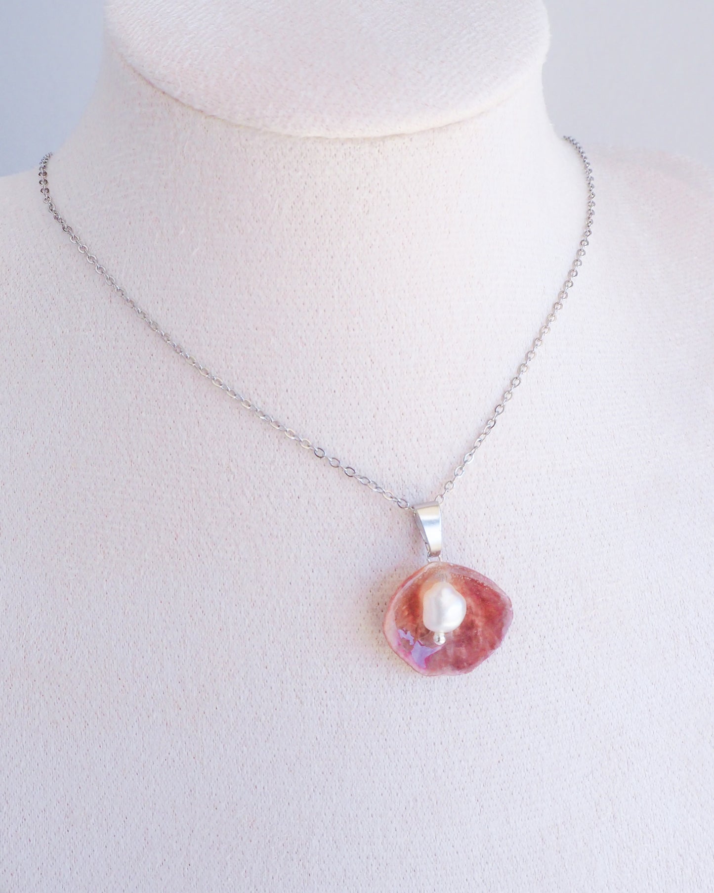 Fuchsia Jingle Shell Silver Necklace with freshwater pearl, Mother of Pearl Pendant on display