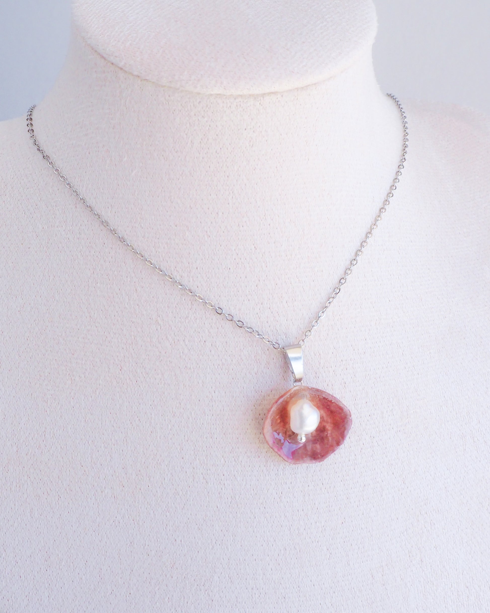 Fuchsia Jingle Shell Silver Necklace with freshwater pearl, Mother of Pearl Pendant on display