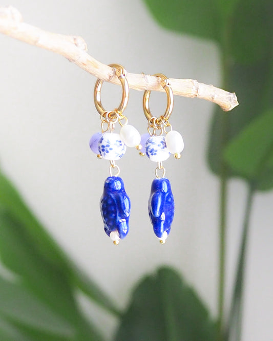 Gold Turtle Azulejo Tile Earrings with Gemstones and Freshwater Pearls on display