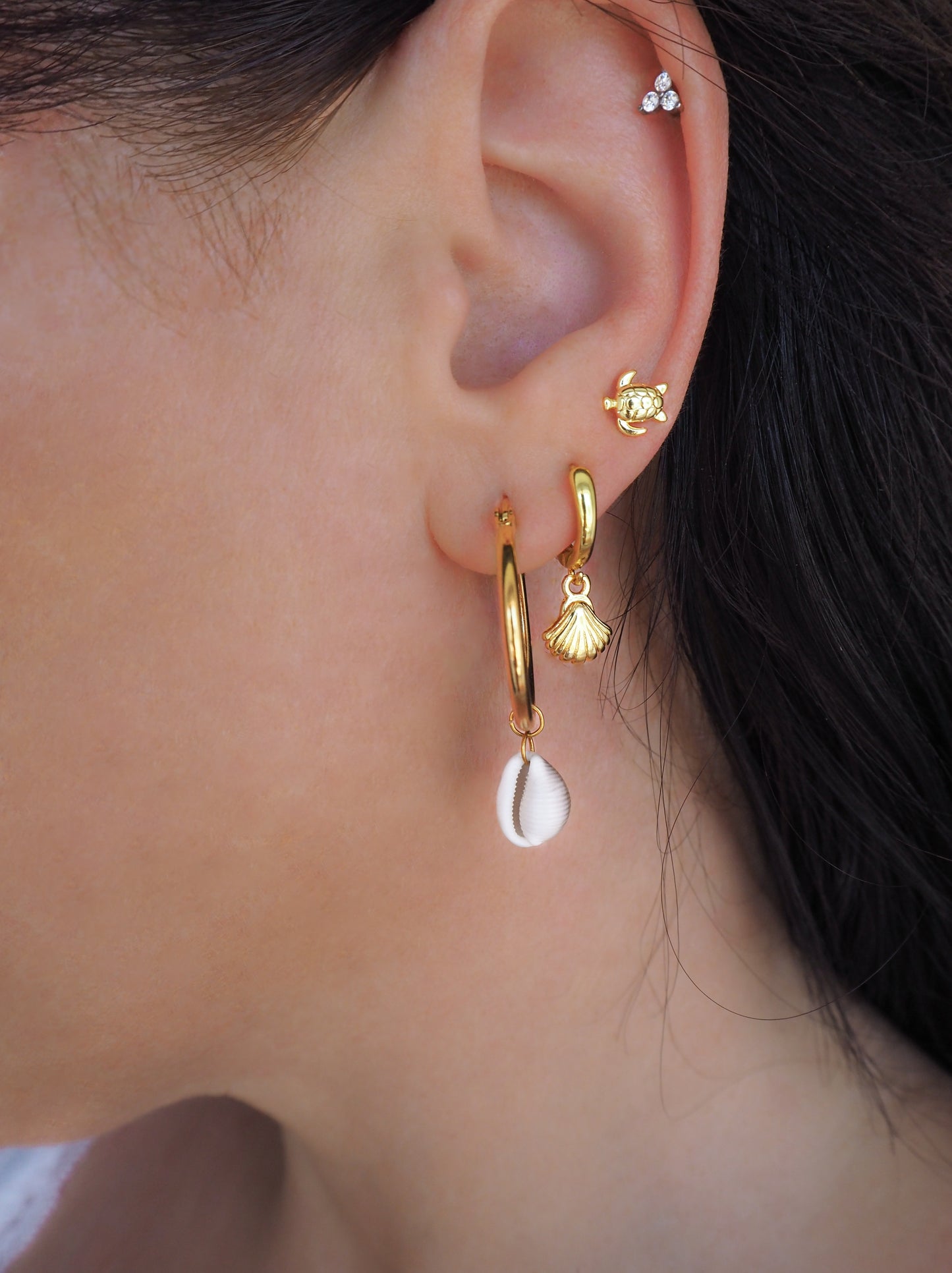 Tiny Turtle Stud earrings gold and silver on model