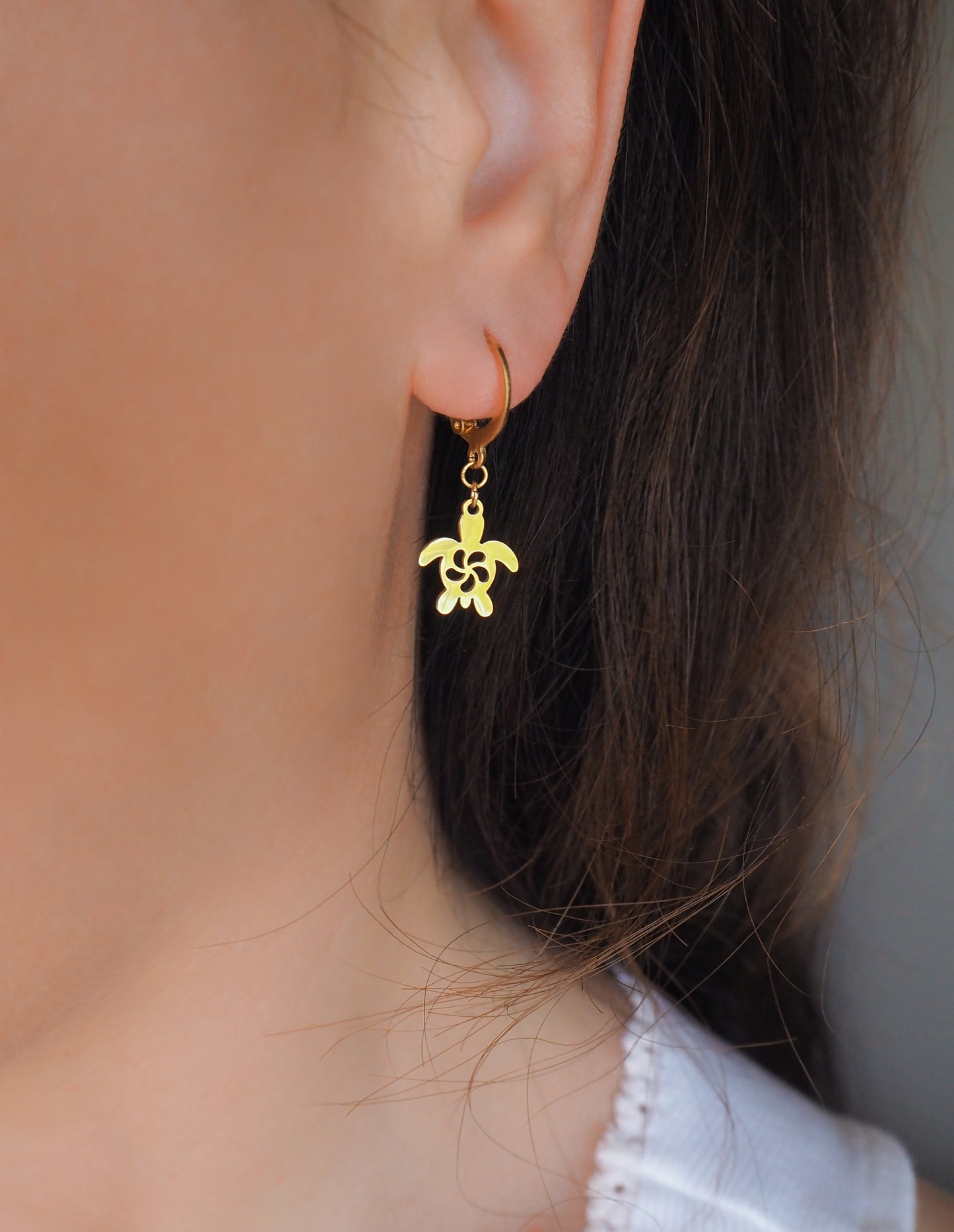 Gold Turtle Hoop Earrings in ear