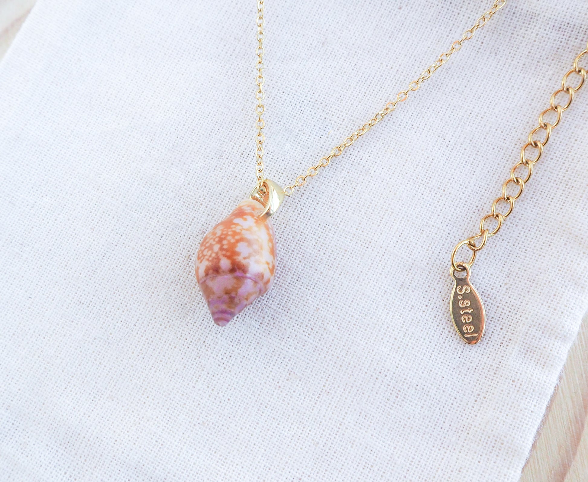 Tiny Dove Shell Gold Necklace on display, Tiny shell from Portugal