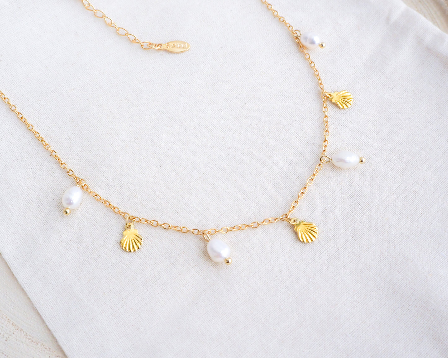 Gold Tiny Shell with Freshwater Pearls on display