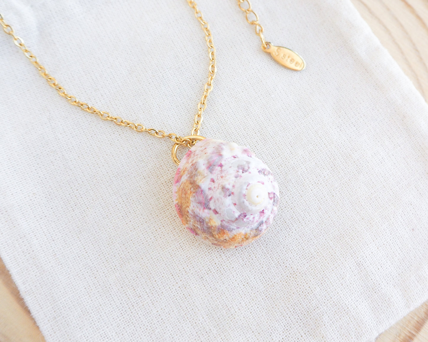 Sunny Pink White Orange Magus Top Shell Gold Necklace on display