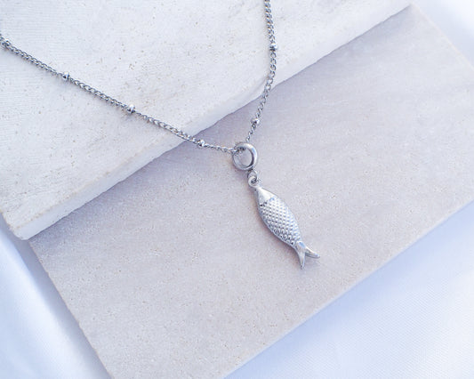 Sardine Fish Silver Necklace on stone