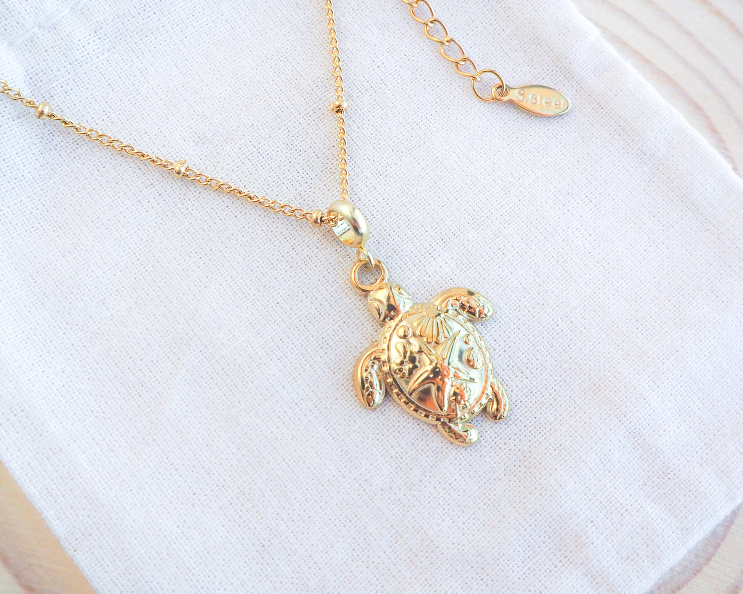 Gold Big Sea Turtle Necklace on display