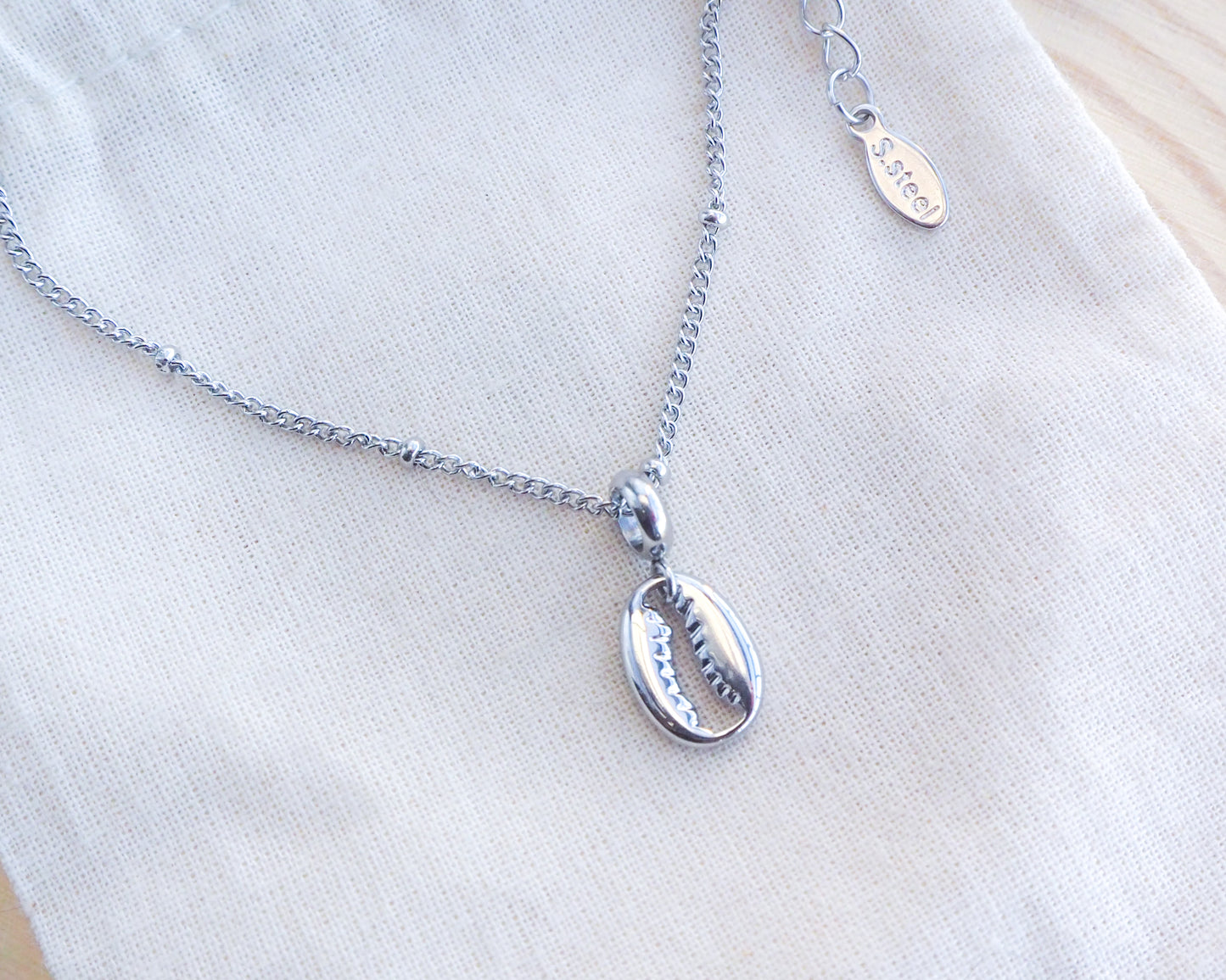 Silver Cowrie Necklace on display