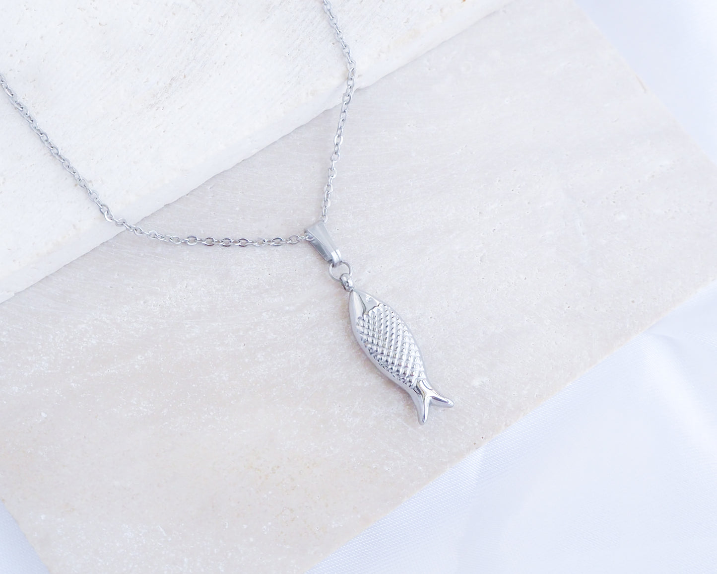 Silver Sardine Fish Necklace displayed on stone, Sardine Fish Jewelry from Portugal