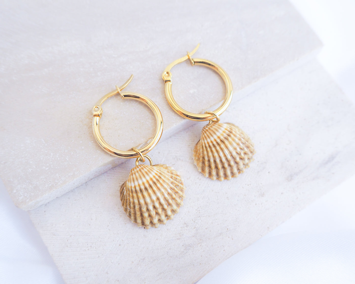 Sunny Mediterranean Cockle Shell Gold Earrings from Portugal displayed on stone, handpicked yellow cockle shells from Portugal, seabylou, ocean inspired earrings, beach gift