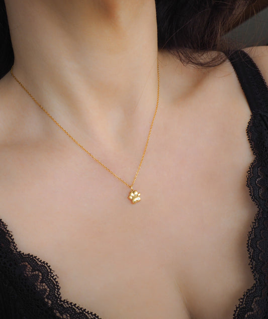 Model wearing Tiny Cat Paw Gold Necklace on stone displayed, Memory Cat Jewelry, Gold Cat Necklace