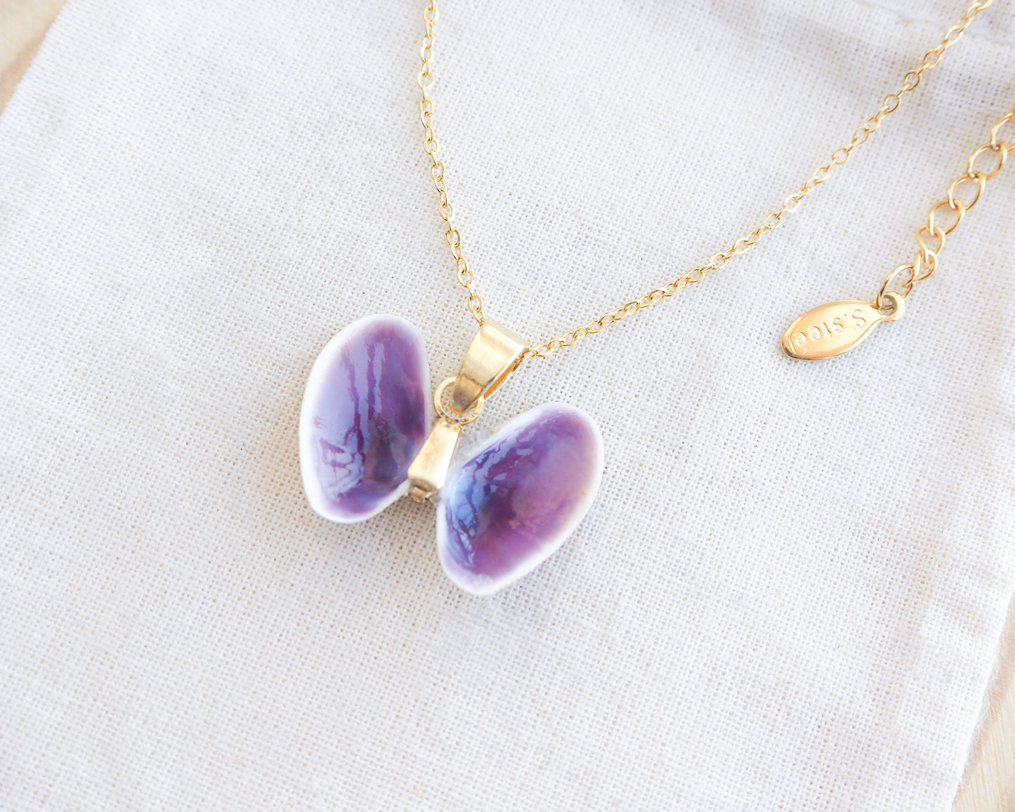 Tiny Purple Butterfly Shell Gold Necklace side view on display, Coquina Shells from Portugal
