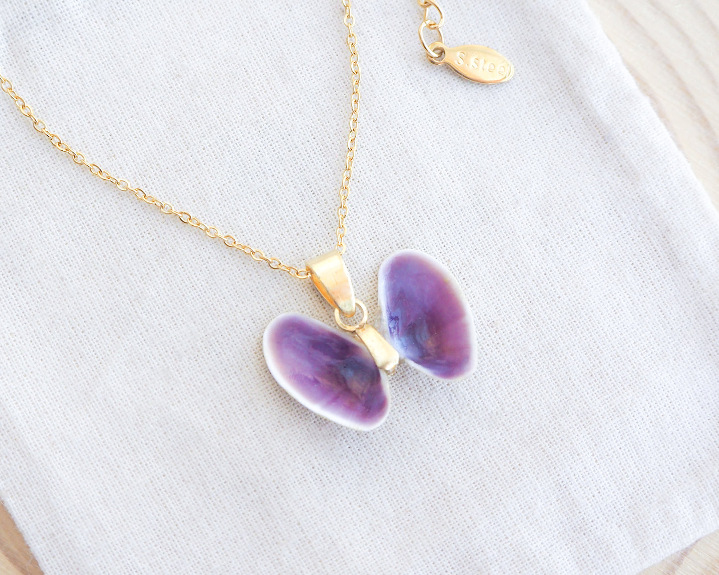 Tiny Purple Butterfly Shell Gold Necklace on display, Coquina Shells from Portugal