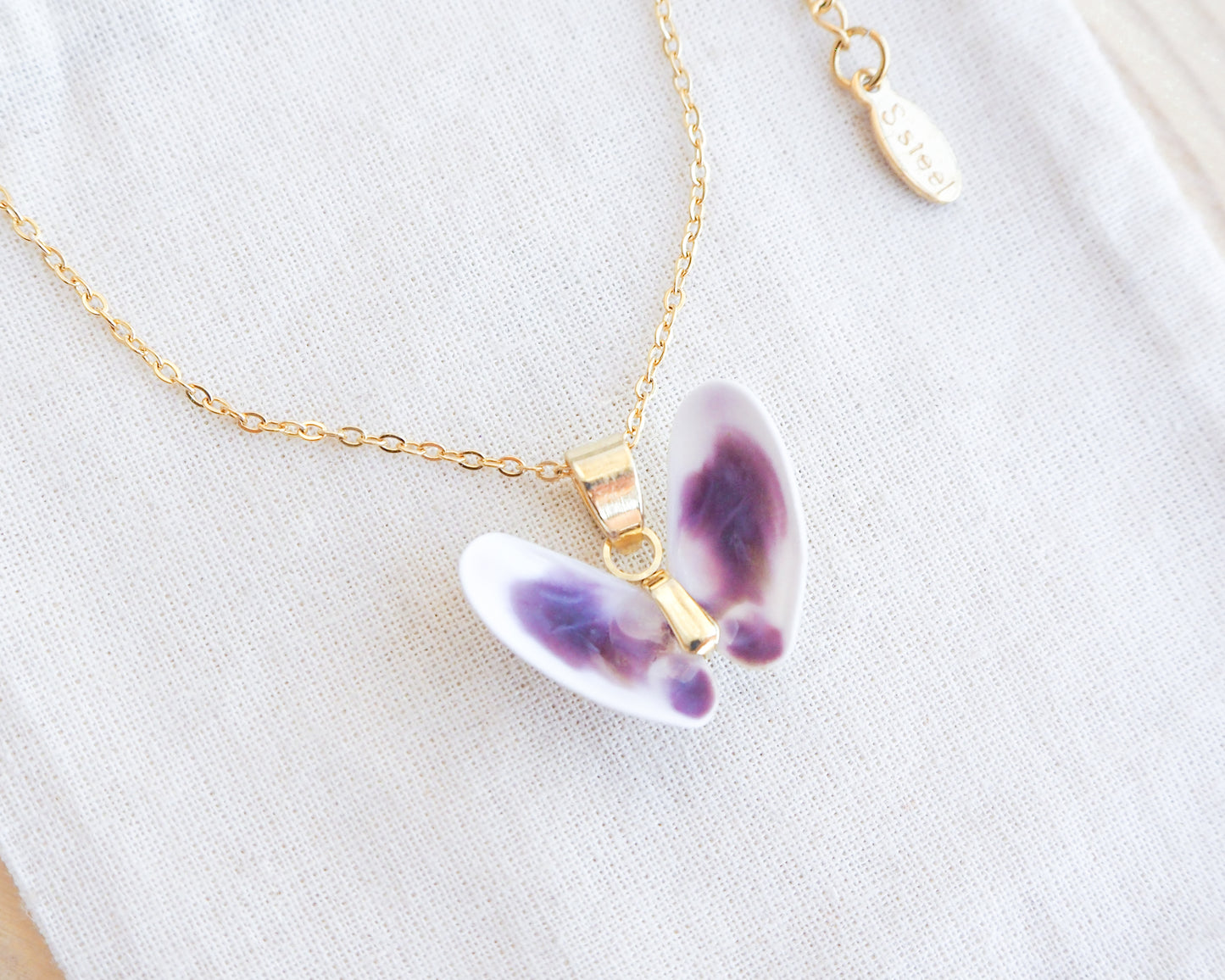 Tiny Purple White Coquina Butterfly Shells Gold Necklace on display