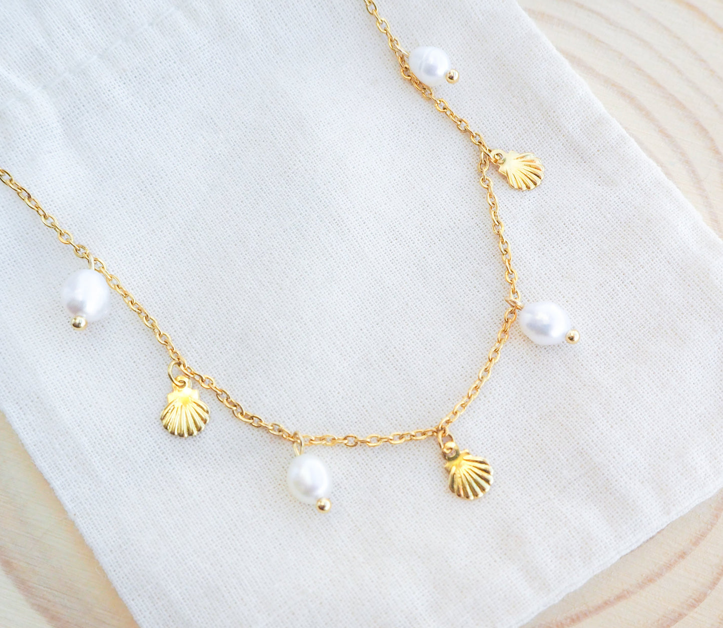 Gold Tiny Shell with Freshwater Pearls on display