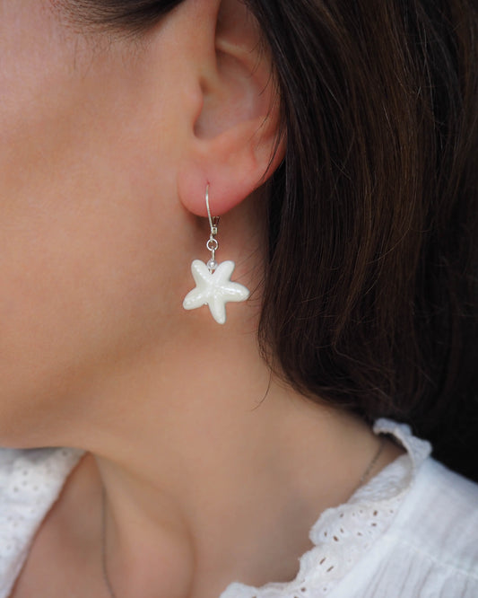 White Ceramic Starfish Silver Earrings in ear