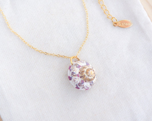White Fuchsia Magus Top Shell Necklace on display