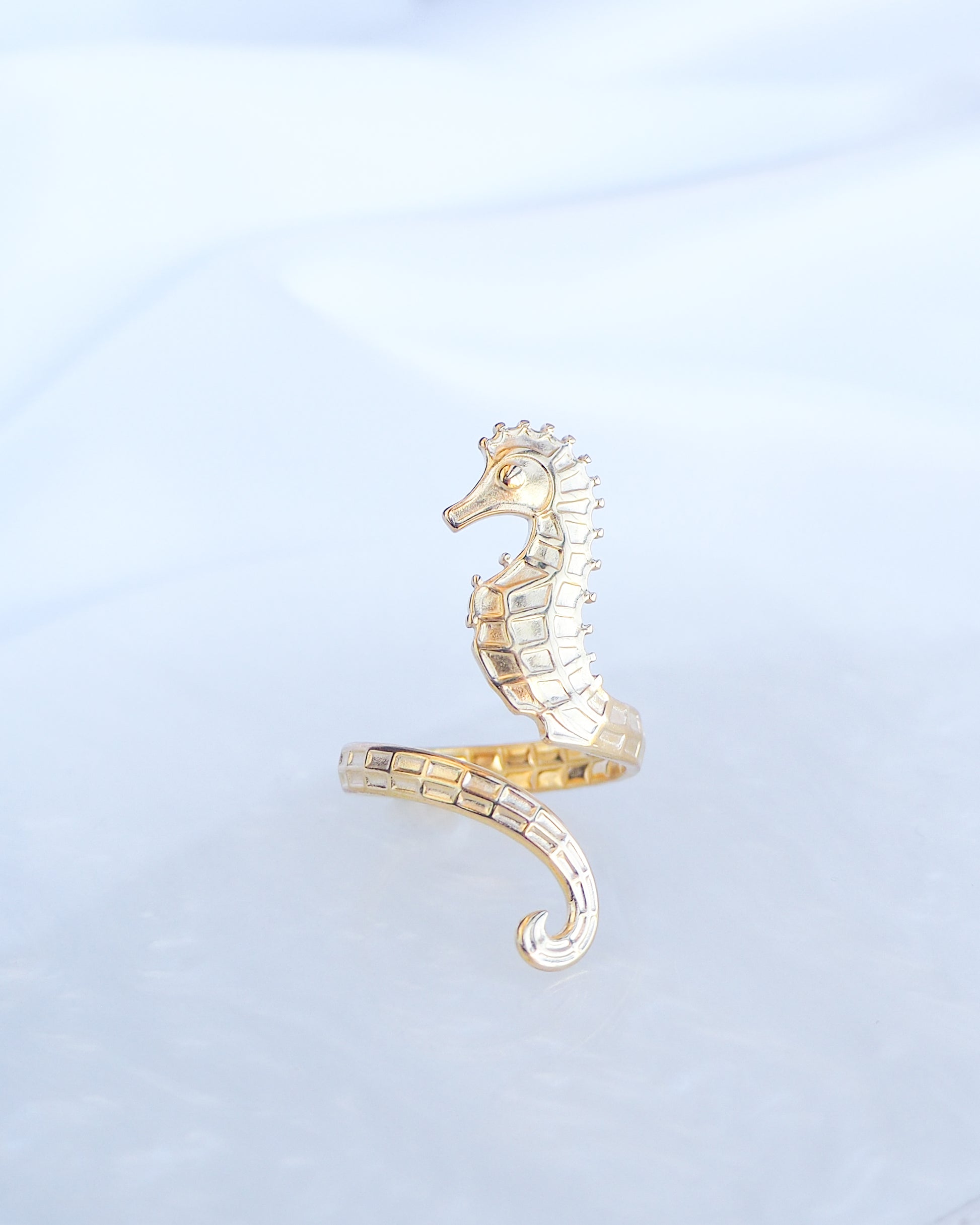 Front view of Gold Seahorse Ring on a light background, made with 18k gold stainless steel and adjustable size