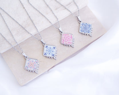Portuguese Tile Necklace Floral Blue Silver on stone displayed. Made with silver stainless steel and white blue floral and pink floral pendant inspired by the Portuguese Azulejo design pattern. 