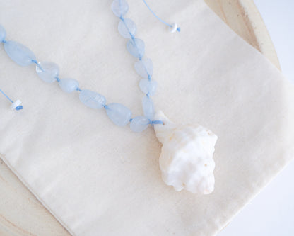 Big white Murex Shell Necklace with Aquamarine Gemstone Beads on display, Blue gemstone bead necklace with off white big conch shell, Handpicked Banded Dye-murex shell from Portugal
