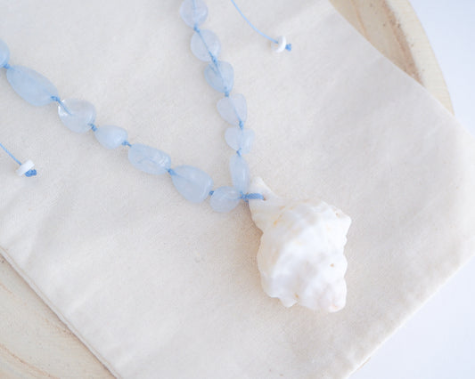 Big white Murex Shell Necklace with Aquamarine Gemstone Beads on display, Blue gemstone bead necklace with off white big conch shell, Handpicked Banded Dye-murex shell from Portugal