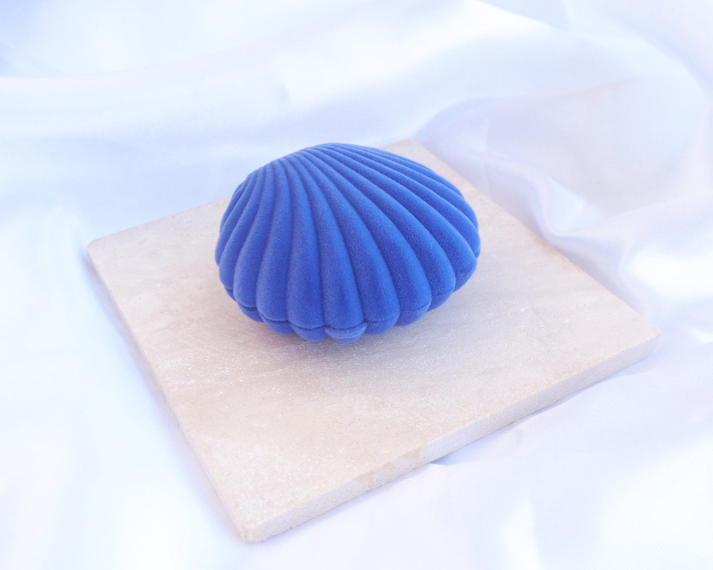 Side view of Blue Velvet Seashell Jewelry Box, Shell shaped jewelry box blue velvet seashell jewellery box on stone displayed 
