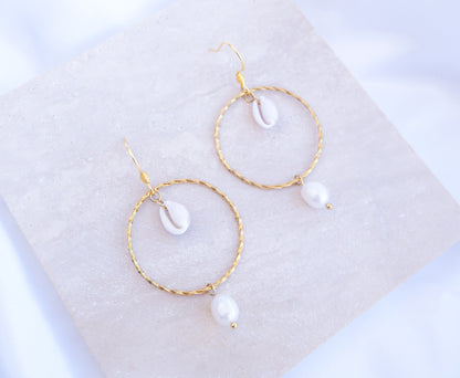 Boho Chic Cowrie Shells Pearl Hoop Earrings on stone displayed, 18k Gold Stainless Steel Hoop earrings with tiny cowrie shells handpicked from Portugal. Conchas Beijinhos, Ivory freshwater pearls, seabylou 