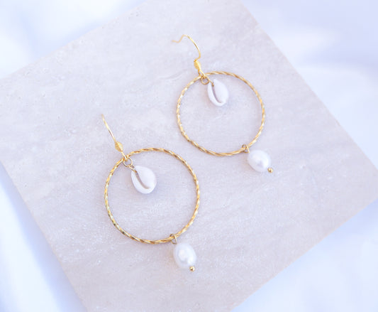 Boho Chic Cowrie Shells Pearl Hoop Earrings on stone displayed, 18k Gold Stainless Steel Hoop earrings with tiny cowrie shells handpicked from Portugal. Conchas Beijinhos, Ivory freshwater pearls, seabylou 