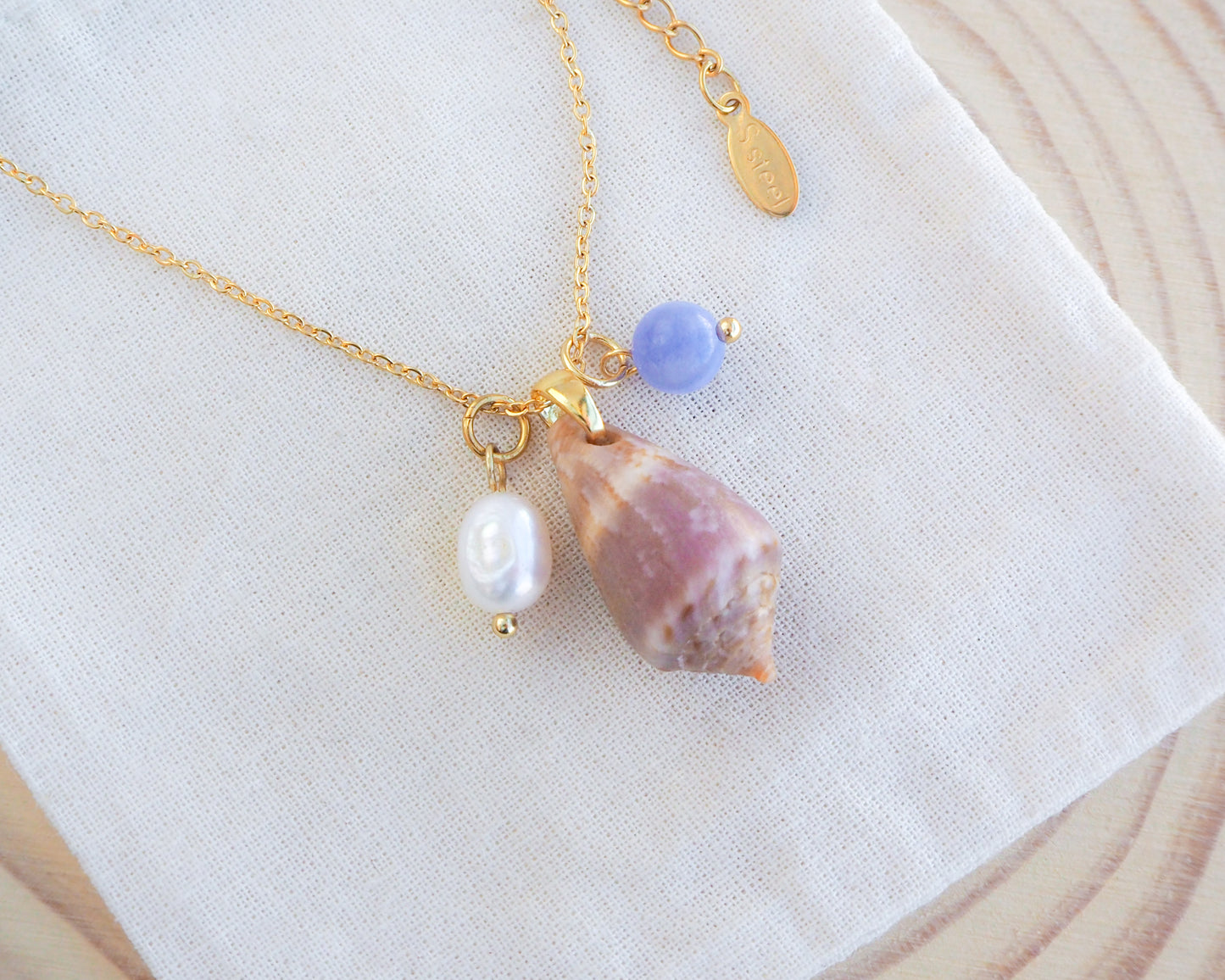 Cone Shell Gemstone Pearl Trio Necklace Medium on display