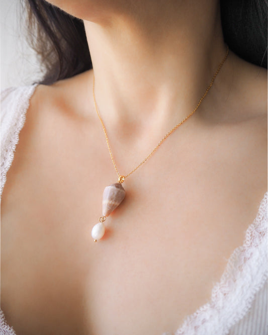 Model wearing Mediterranean Cone Shell Pearl Necklace Reversed from Portugal, handpicked cone shell from Algarve, Freshwater pearl and 18k gold stainless steel chain