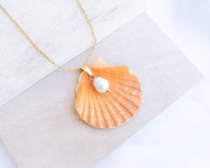 Coral Orange Scallop Shell Pearl Gold Necklace II on stone displayed, Pilgrims Scallop Shell from Portugal with freshwater pearl and gold chain.