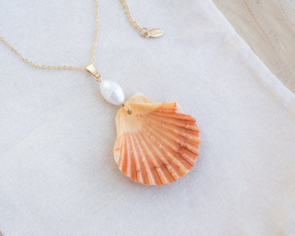 Coral Orange Scallop Shell Pearl Gold Necklace IV on display, Pilgrims Scallop Shell from Portugal with freshwater pearl and gold chain. 