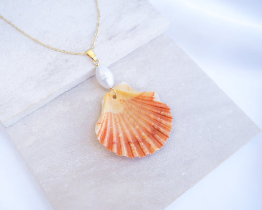Coral Orange Scallop Shell Pearl Gold Necklace IV on stone displayed, Pilgrims Scallop Shell from Portugal with freshwater pearl and gold chain. 