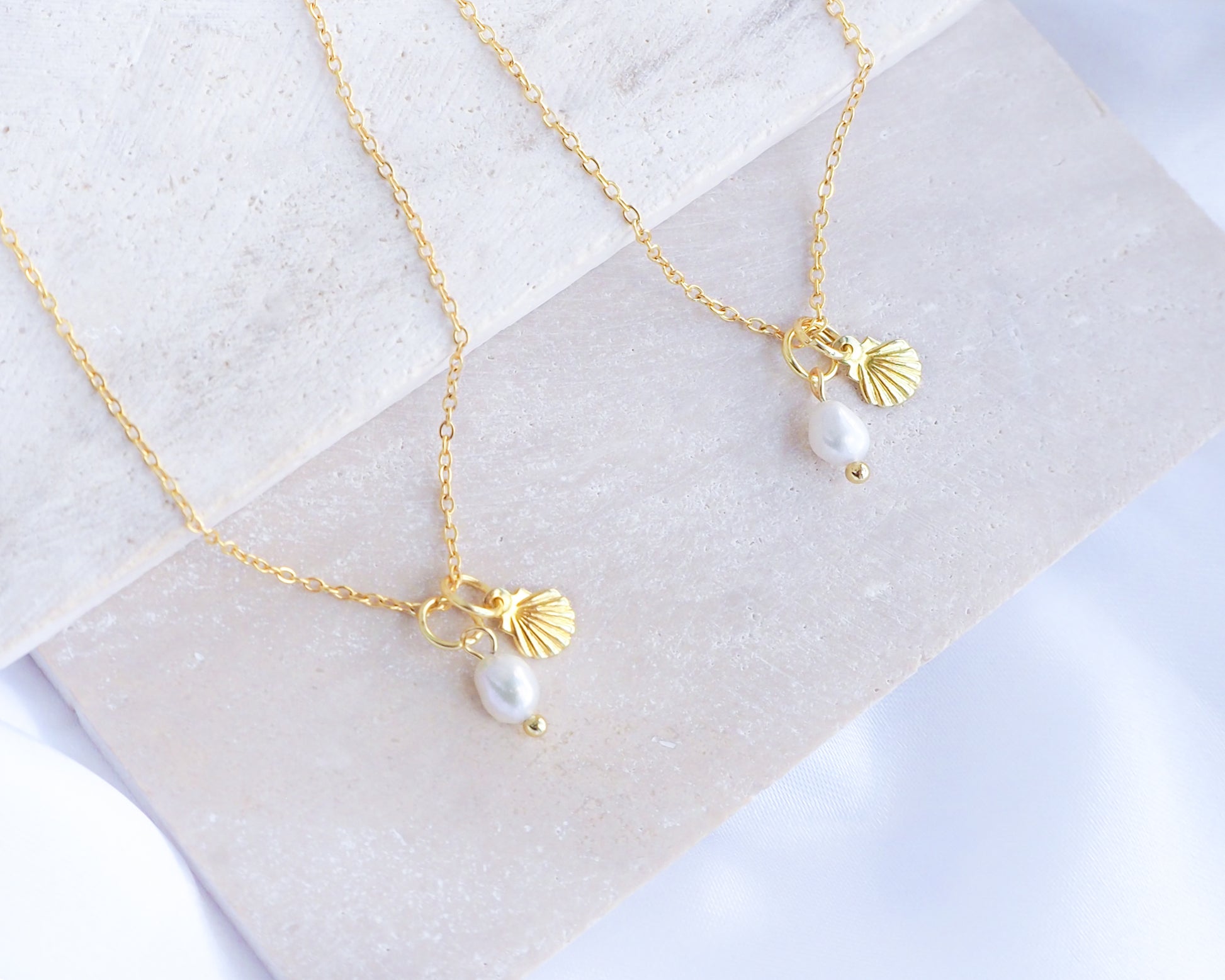 Dainty Gold Shell Pearl Necklaces on stone with freshwater pearls and 18k gold dainty shell pendants