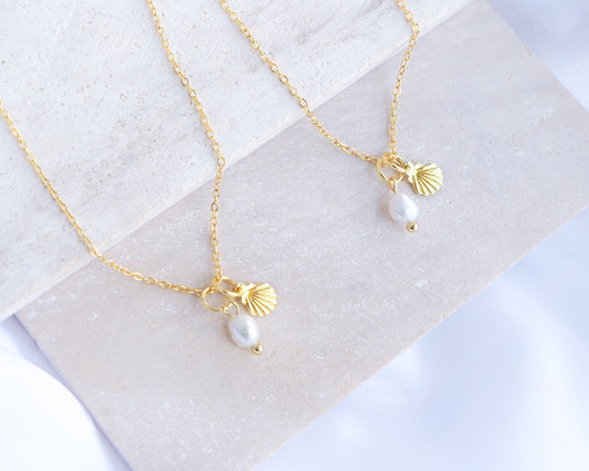 Dainty Gold Shell Pearl Necklaces on stone with freshwater pearls and 18k gold dainty shell pendants