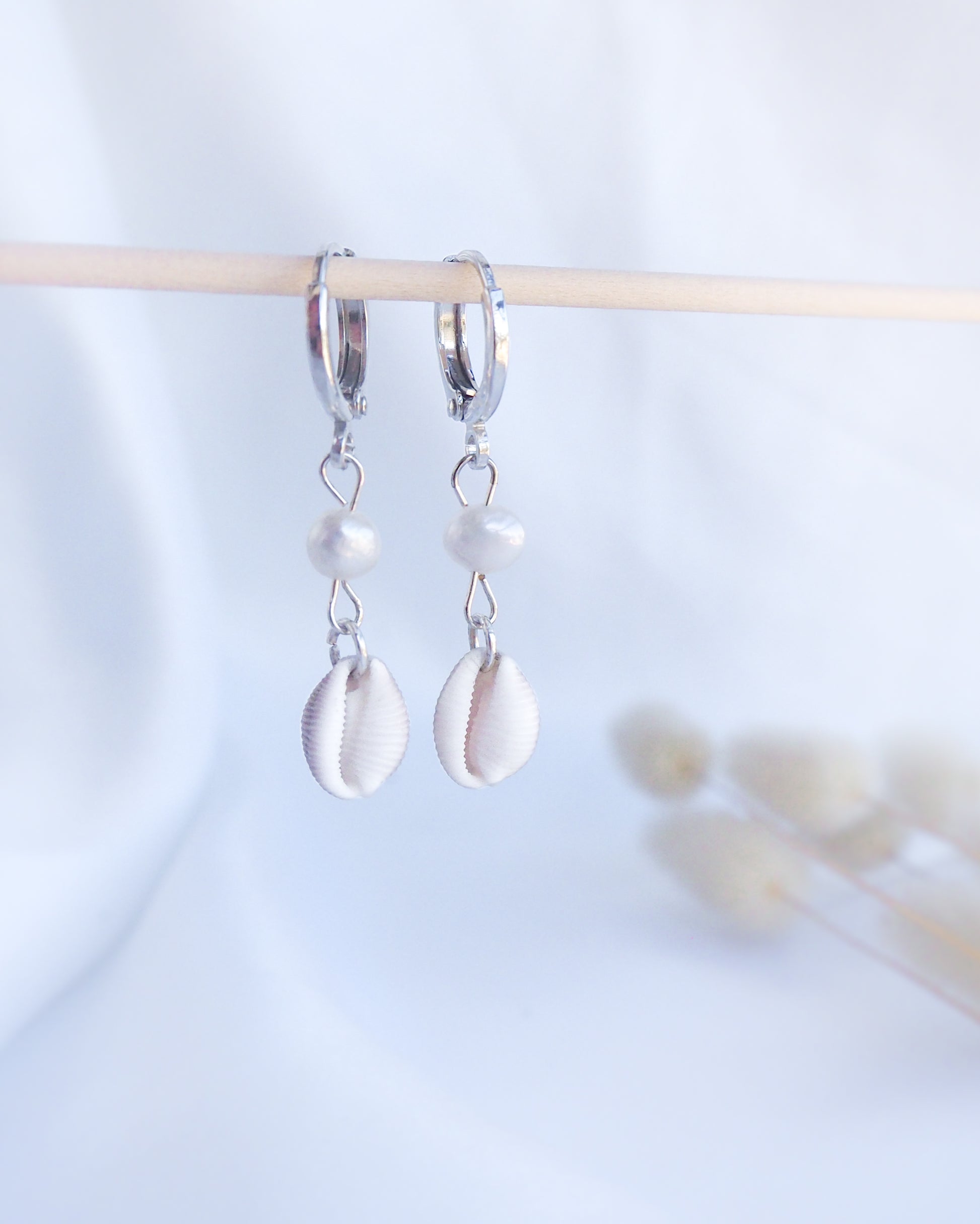 Front view of 925 sterling silver european cowrie shell earrings with freshwater, handpicked trivia monacha shell from portugal, coastal wedding jewelry