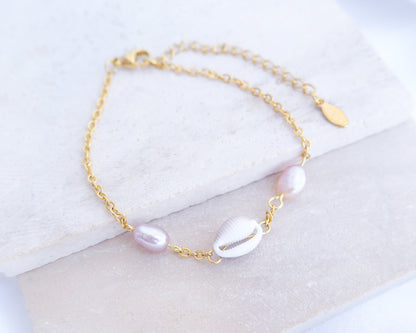 European Cowrie Shell and Freshwater Pearl Gold Bracelet on stone displayed, tiny cowrie shell pearl bracelet with handpicked cowrie shell from Portugal