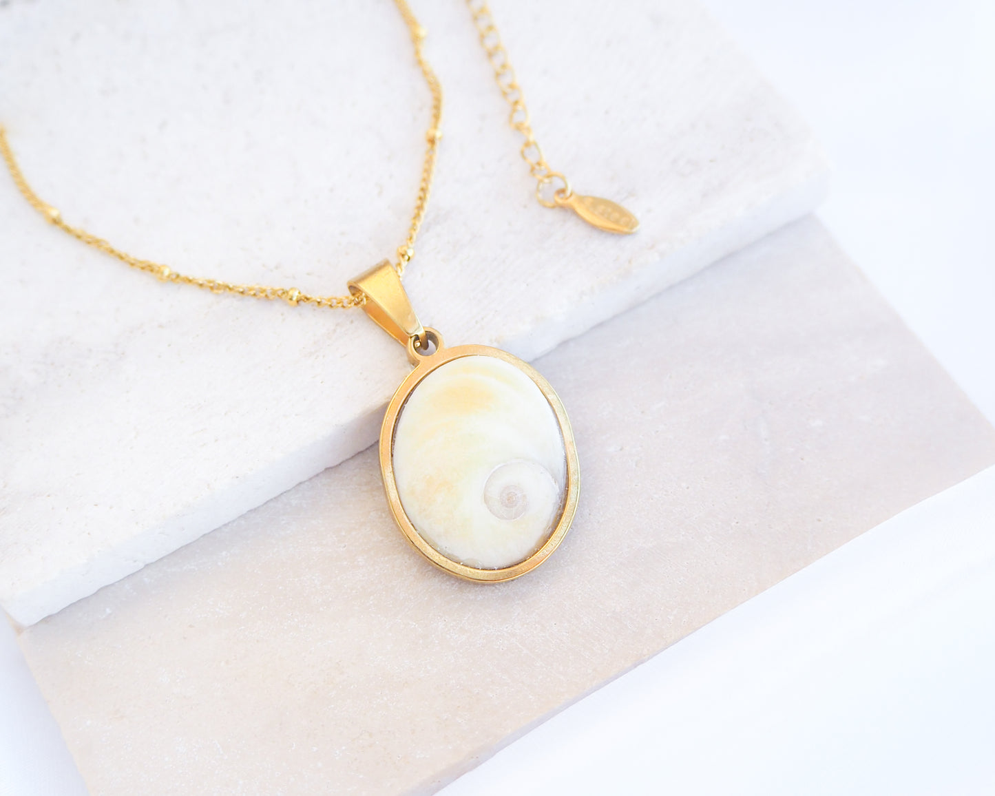 Eye of Saint Lucia Gold Necklace on stone displayed, 18k gold stainless steel shiva eye pendant necklace, Saint Lucy Eye, operculum pendant
