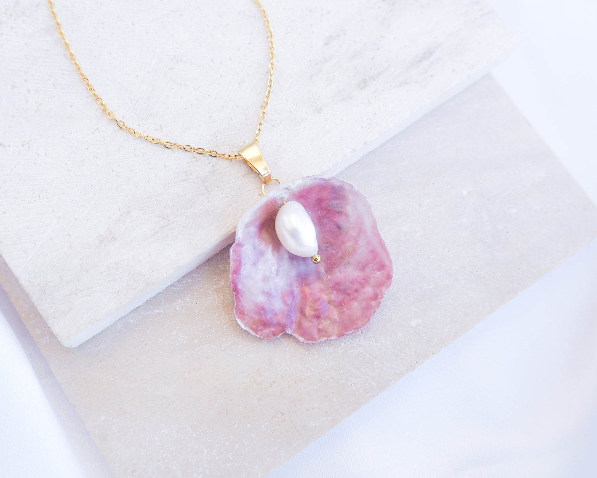 Close up of Fuchsia Pink Pearl Shell Necklace V displayed on stone, Gold Pearly Pink Oyster Shell Necklace, Fuchsia Pink Pearly Shell handpicked from Portugal, Sea by Lou, Mother of Pearl Shell Portugal 