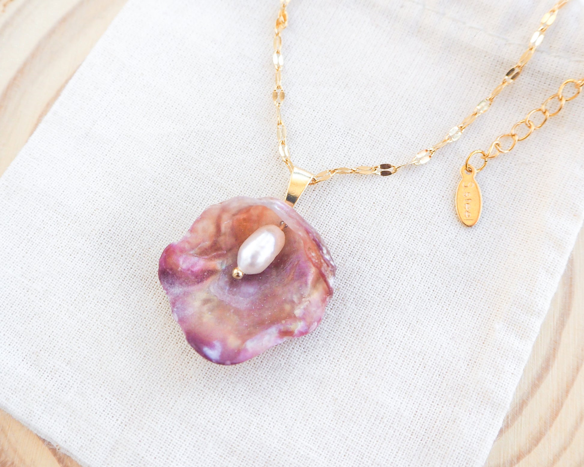 Fuchsia Pink Pearly Shell Necklace, Gold Jingle Shell Necklace on display, Sea by Lou, Mother of Pearl Shell Portugal 