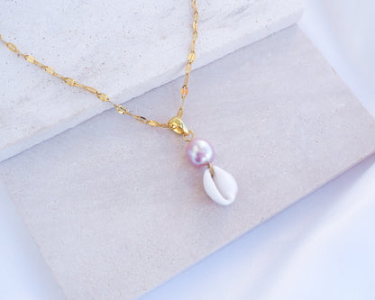 Deluxe Gold Necklace with Tiny Cowrie Shell from Portugal and a Pink Rose Pearl on display
