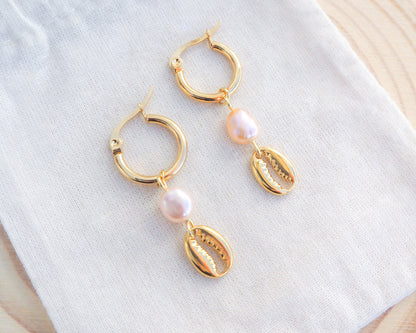 Gold Hoop Earrings with Cowrie Shells and Pearls on display