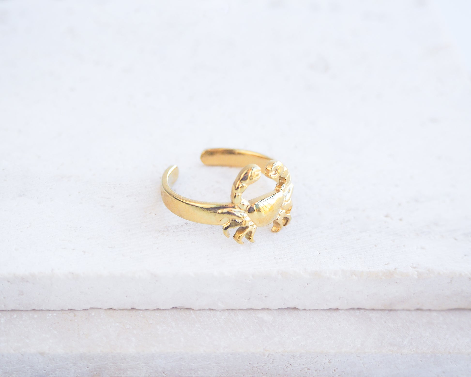 Side view of Gold Cancer Zodiac Ring on stone displayed, adjustable 18k gold stainless steel crab ring 