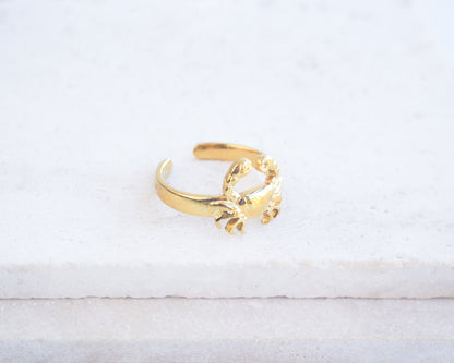 Side view of Gold Cancer Zodiac Ring on stone displayed, adjustable 18k gold stainless steel crab ring 