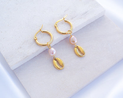 Gold Hoop Earrings with Cowrie Shells and Pearls on stone 