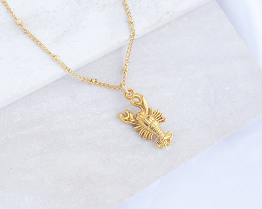 Gold Lobster Necklace on stone displayed, made with 18k gold stainless steel, coastal jewelry from Portugal