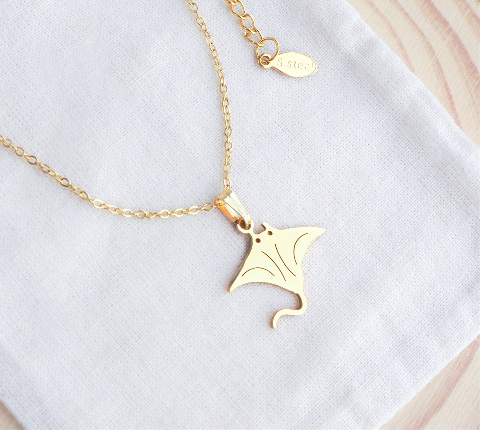 Gold Manta Ray Necklace on display