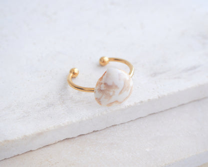 Side view of Norwegian Cockle Shell Gold Ring on stone, 18k gold stainless steel adjustable ring, handpicked cockle shell from Portugal 