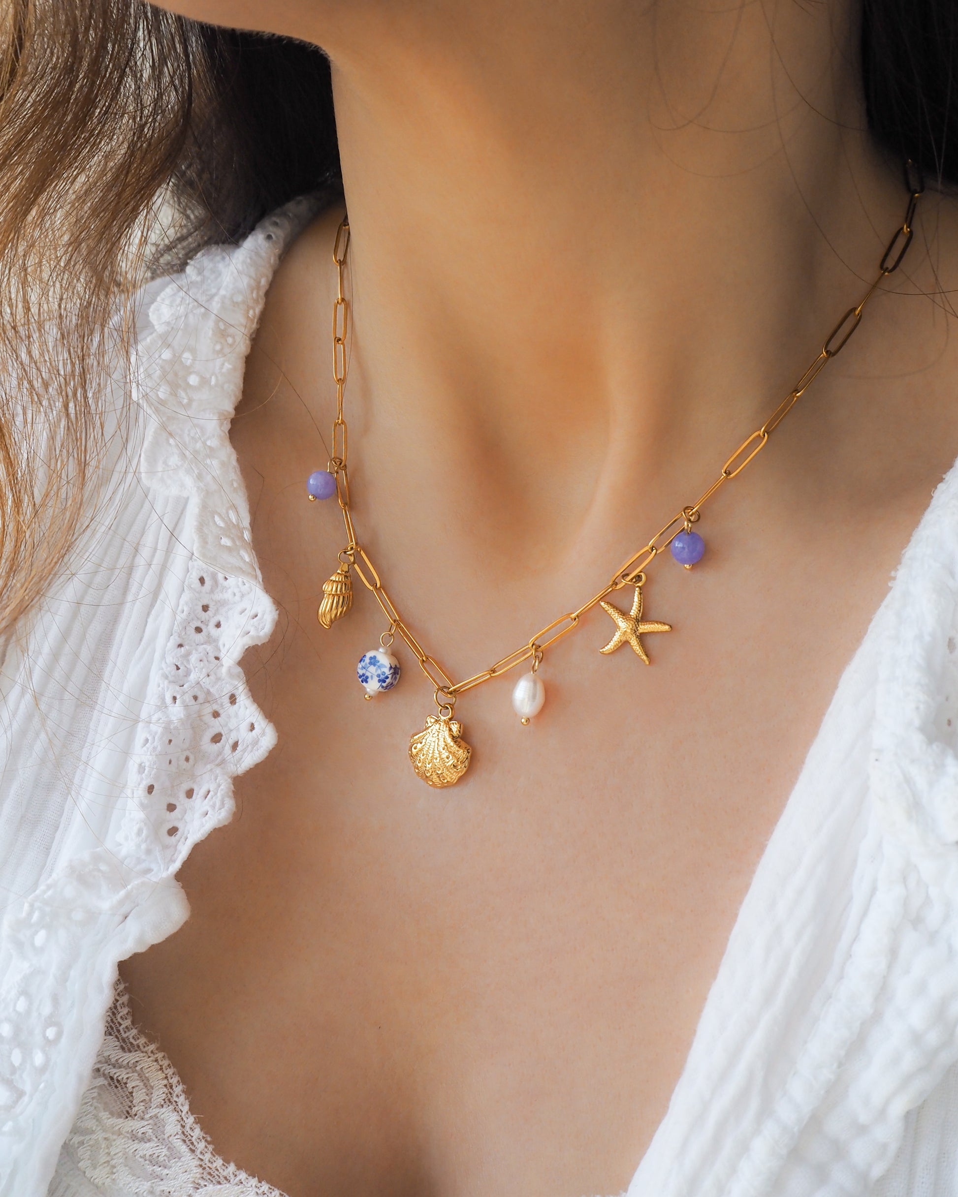 Oceanic Charm Necklace with Shells and Starfish Pendants, Freshwater Pearls and Gemstones on neck model