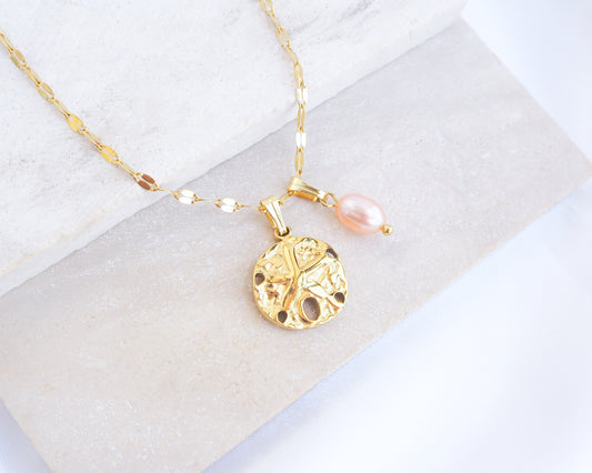 Gold Sand Dollar Rose Freshwater Pearl Deluxe Necklace on display, close up of 18k gold Sand Dollar Pendant with deluxe chain 
